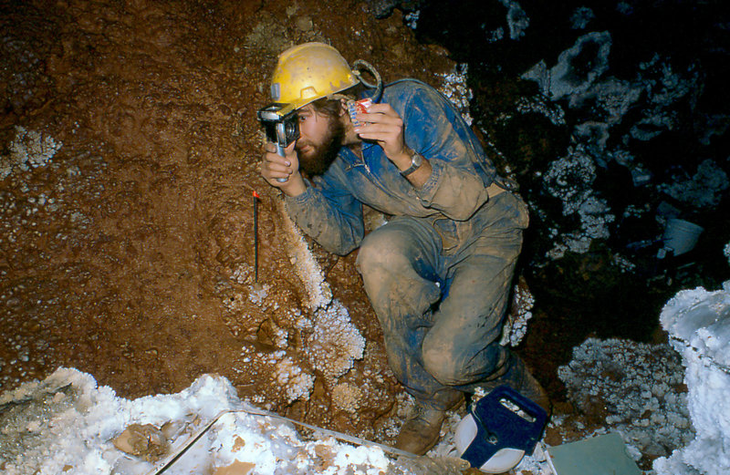 Dave Crombie surveying in stream passage under Krakatoa Cang